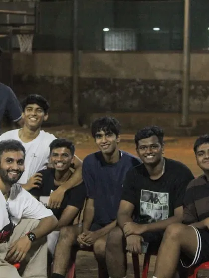 A group of young players hanging out on the sidelines, supporting their friends and enjoying the tournament atmosphere.