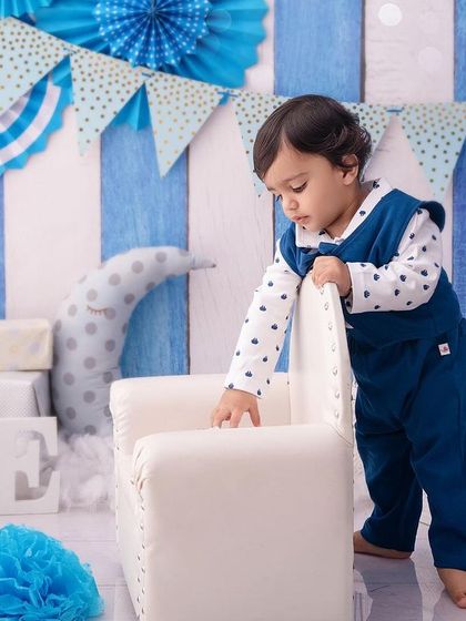 This little gentleman is exploring his birthday setup, a candid moment of a toddler on the move.
