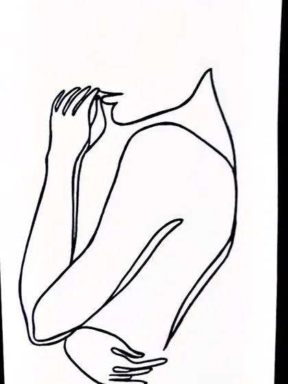 A faceless figure drawn with a single line, conveying emotion through posture alone. This abstract line art is a great example of how minimalism can be deeply expressive.