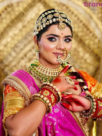 The elegance of a traditional bride. This pose highlights the detailed hand and arm jewelry, along with the flawless makeup application.