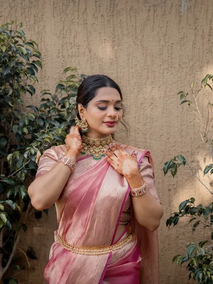 Capturing the intricate details of Isha's jewelry and the flawless application of her makeup. A truly timeless South Indian bridal look.