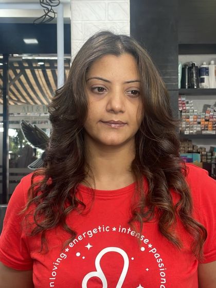 A medium-length layered cut styled with soft waves, creating a look that is both casual and chic.