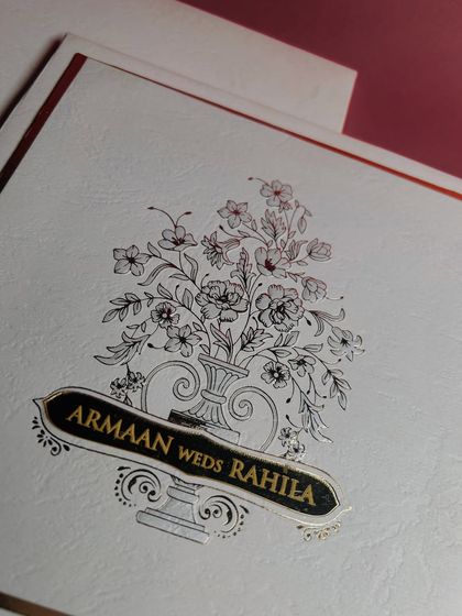 A classic and elegant approach to personalization. Here, the couple's names are featured on a golden banner that is beautifully integrated into a hand-sketched floral design.