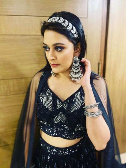 A simple yet impactful party makeup look featuring classic smokey eyes. Paired with a modern black and silver lehenga and statement jewelry, this is perfect for a sangeet or reception.
