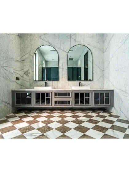This bathroom features a double vanity with twin arched mirrors, perfect for a shared space. The checkerboard marble floor and grey cabinetry continue the modern-classic theme of the home.