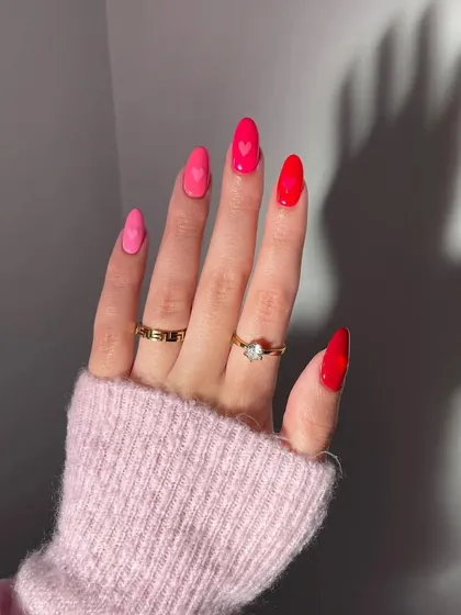 A playful and romantic set perfect for any occasion. This design features a gradient of pink and red shades on almond nails, with tiny, minimalist hearts for a sweet touch.