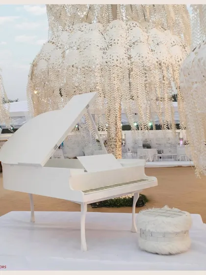 A close-up of the white piano, a symbol of classic romance. Set against the backdrop of the white leaf trees, it completes the fairytale vision.