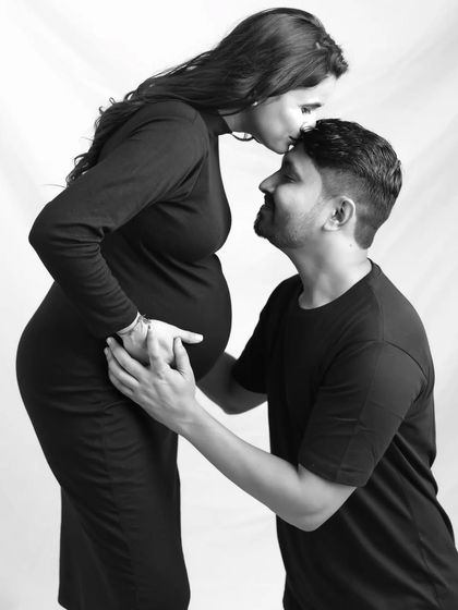A loving kiss on the forehead. This black and white portrait is timeless and emotional, capturing a quiet moment of love and protection.