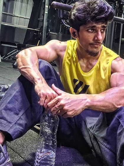 Taking a moment to rest and rehydrate during a tough gym session. Pushing your limits requires proper recovery to build strength effectively.