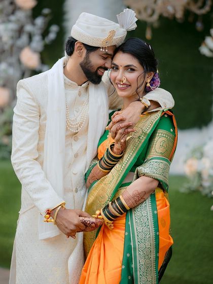 A joyful embrace between the newly-engaged Marathi couple, their smiles radiating happiness and love.