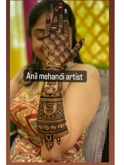 A client posing with her beautiful arm mehandi. The design includes traditional figures and patterns, creating an elegant look for her special occasion.