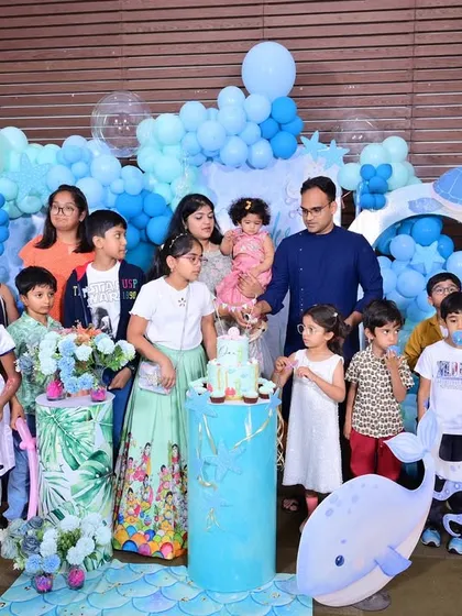 All the children gathered with the birthday girl and her family for a group photo, capturing a memorable moment from the party.
