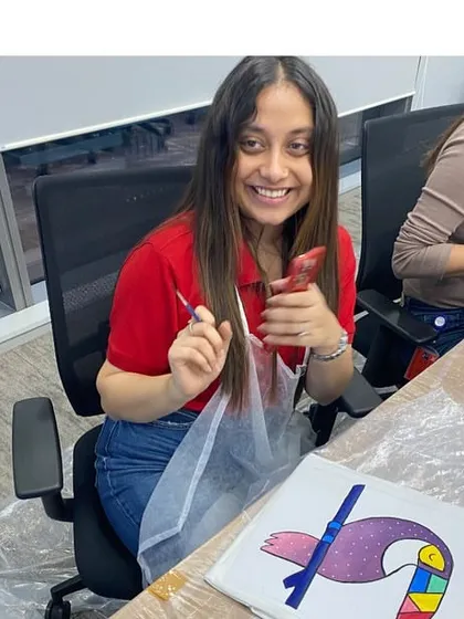 The joy of the process! A happy participant fully engaged in painting her canvas during one of my corporate workshops. It’s all about having fun and trying something new.