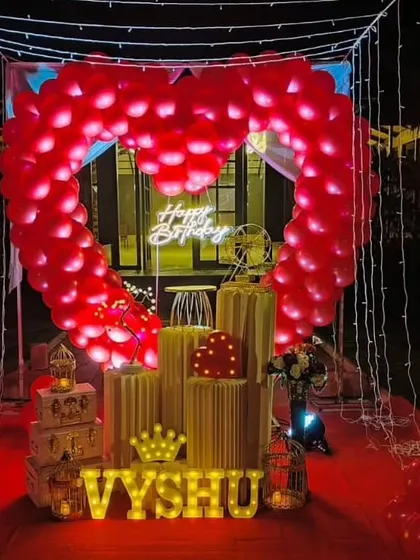 We specialize in creating unforgettable romantic surprises. This stunning outdoor cabana setup features a heart-shaped balloon arch, a red carpet entrance, and magical fairy lights, perfect for a birthday or anniversary celebration.