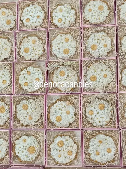 A bulk order of my daisy urli candles, each packed individually in a pink gift box with natural fiber bedding. This shows how I prepare large orders for gifting, ensuring each candle is presented beautifully.