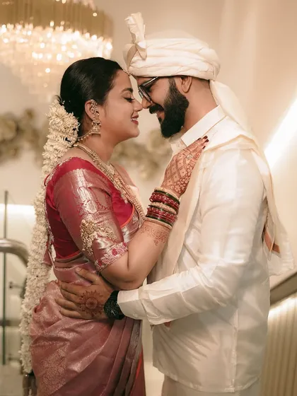 An intimate embrace, capturing the beautiful details of the bride's silk saree and the couple's connection.