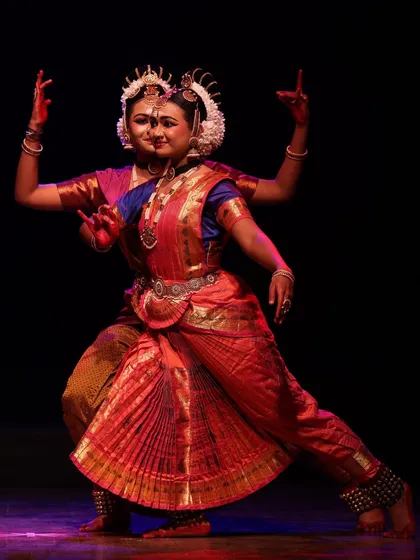 Two dancers creating a beautiful composite form, their bodies merging to depict a multi-armed deity, a highlight from the Sadhana festival.