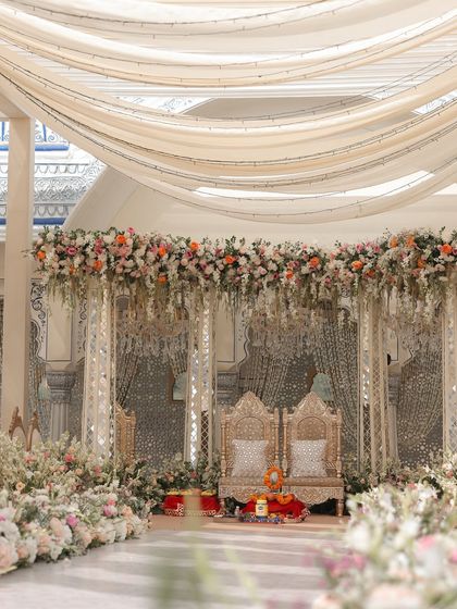 A wider view of the pastel mandap, showing the beautiful draping and the layers of florals that frame the ceremony space. The design feels open, airy, and incredibly romantic.