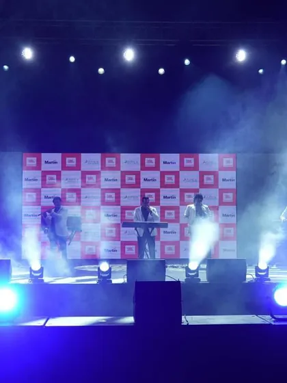 Creating an electric atmosphere for a live music performance at a corporate brand event. Our stage lighting design uses dynamic beams and atmospheric smoke to immerse the audience and put the artists in the spotlight.