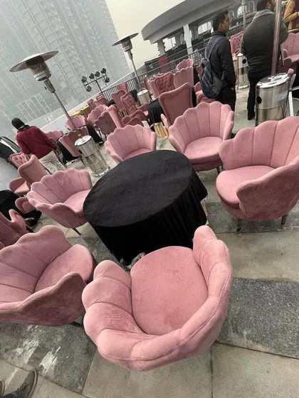 Another angle of the stylish rooftop lounge, showcasing the unique design of the pink velvet chairs.