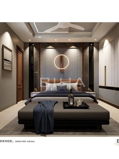 For this guest bedroom in Greater Noida, we created a welcoming and refined space. The design features a leatherette headboard and a distinctive circular light fixture, complemented by a full wall of wardrobes with elegant metallic handles, ensuring ample storage for visitors.