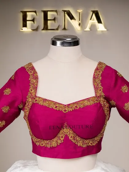 The classic Katori blouse is all about the perfect fit and timeless charm. This version in magenta raw silk is adorned with simple but elegant gold butti embroidery, making it a versatile choice for any traditional event.