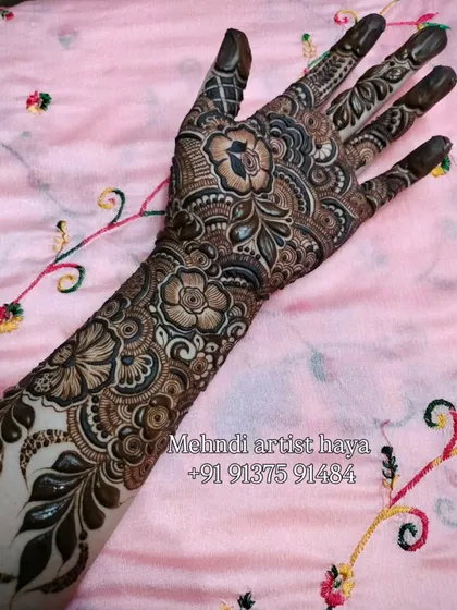 This design is a beautiful chaos of flowers and vines. The pattern is dense and detailed, perfect for a bride who wants a rich and traditional look.