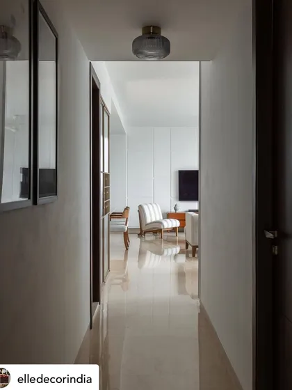 The hallway provides a clean, bright passage into the living area. This view highlights the polished marble floors and the seamless transition between spaces, a hallmark of our thoughtful layout planning.