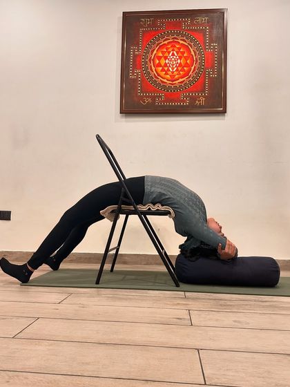 Therapeutic yoga can be a powerful tool for strengthening the immune system. This supported backbend over a chair and bolster helps to lower stress hormones like cortisol, which are known to compromise immune function.