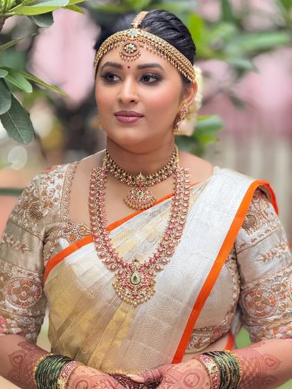 A three-quarter portrait of the bride, showcasing her beautiful jewelry and the soft, glowing makeup that enhances her features.