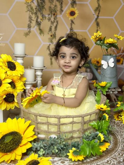 A full portrait from the sunflower session, showcasing the pretty yellow dress and the detailed, sunny backdrop.