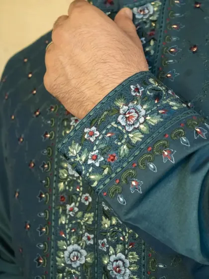 The details matter. Our teal jacket is intricately embellished with multicoloured Resham silk embroideries that add a touch of luxury and elegance.