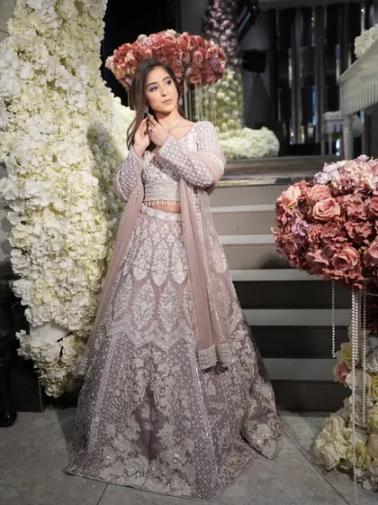 A full-length shot against a stunning floral backdrop. The entire look is a vision of pastel perfection.