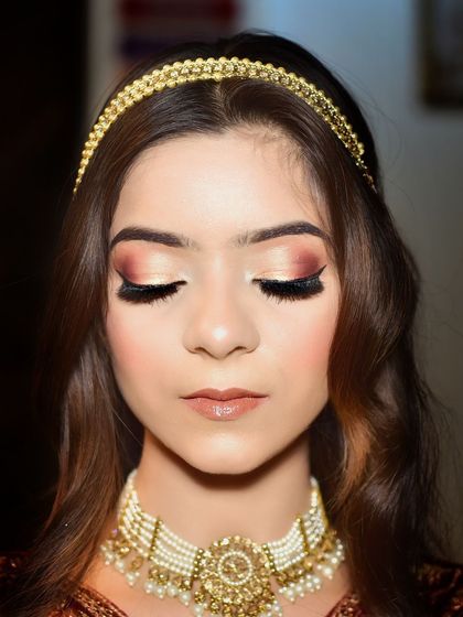 This close up shot is all about the dramatic eye makeup. The perfect winged liner and shimmery eyeshadow are the stars of this glamorous portrait.