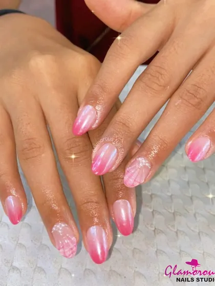 A beautiful pink ombré with a pearlescent finish, complemented by accent nails with a delicate, shell-like 3D texture.