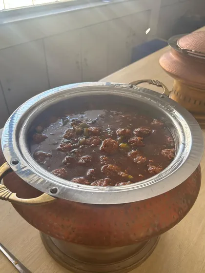 A close-up of the Gobi Manchurian served in a traditional copper pot for a school lunch event. My Indo-Chinese dishes are always a hit, adding a popular flavor profile to any corporate or institutional menu.