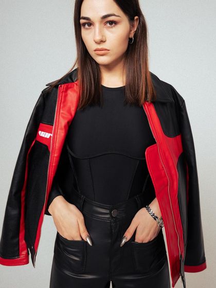 A confident, hands-in-pockets pose. This shot showcases the jacket worn open, giving a clear view of the inner styling and the overall fit.