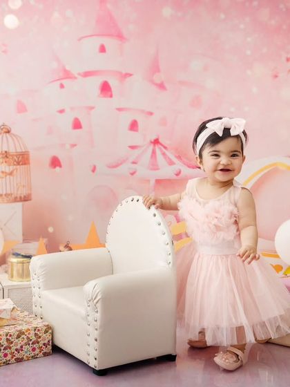 A true princess in her pink castle. This setup is perfect for celebrating a birthday or just capturing some fairytale magic.