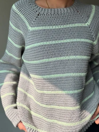 A close-up on the texture and stitch definition of the handmade sweater. Every single stitch is done by me.