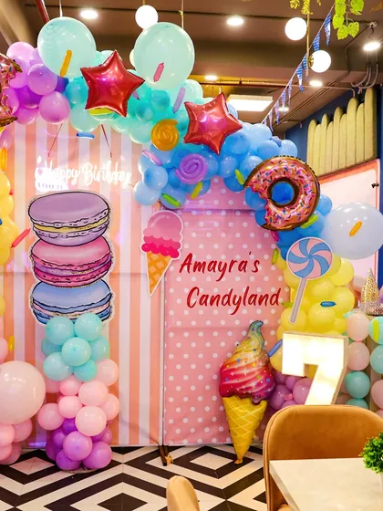 We brought a child's sweet dream to life with this incredible "Candyland" theme. Featuring giant macarons, ice cream cones, and donut balloon arches, our themed party decorations transform the space into a whimsical paradise.