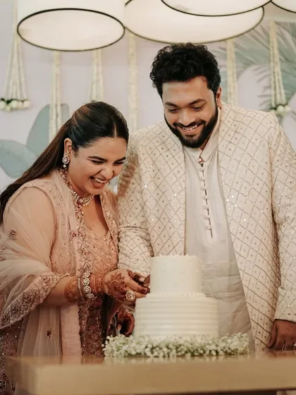 A happy shot of the couple cutting their cake. Her elegant, pulled-back hairstyle was perfect for the daytime event.