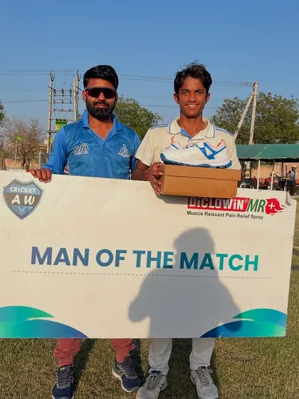 Another shot of Puneet Kumar, proudly holding the Man of the Match board and his prize.