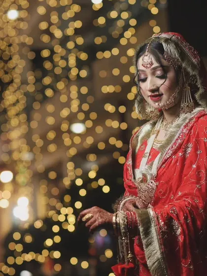 A stunning nighttime portrait of the bride, with fairy lights creating a beautiful, warm glow. We specialize in using lighting to create magical wedding photos.