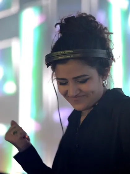 A happy, candid moment behind the decks at a large-scale private function.