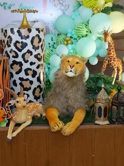 A detailed shot of the animal props and themed cake stands for Caleb's first birthday party.