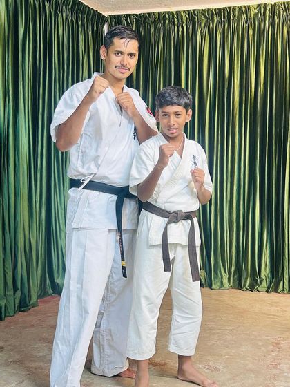 A photo with a promising brown belt student. He is close to achieving his black belt, and camps like this push him closer to his goal.