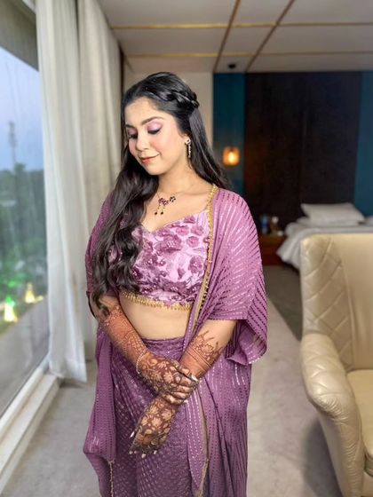 A soft and dreamy Haldi look in a pastel purple outfit. The makeup features a subtle pop of color on the eyes and a glowing base.