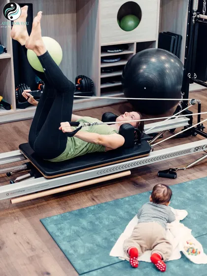 It's never too early to be inspired by movement. While this new mother works on her postnatal recovery and strength, her little one observes from the mat.