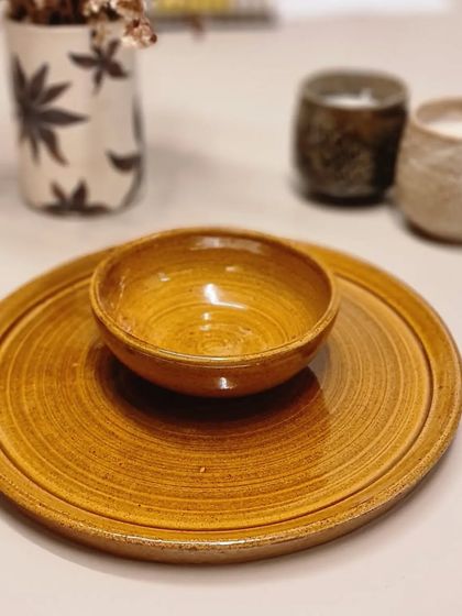 Another one of my Rakhi gift hampers, featuring a textured plate and bowl in a warm, amber glaze. Each piece has a unique character you won't find in mass-produced items.