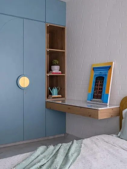 Designing for children means creating a space that is both fun and functional. This daughter's bedroom features a custom C-shaped platform bed, pastel blue arched wardrobes for smart storage, and a rustic brick wall, showing how I tailor each kids' room design to the child's personality.
